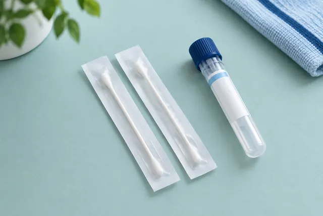 Sterile cheek swabs beside a sealed specimen tube