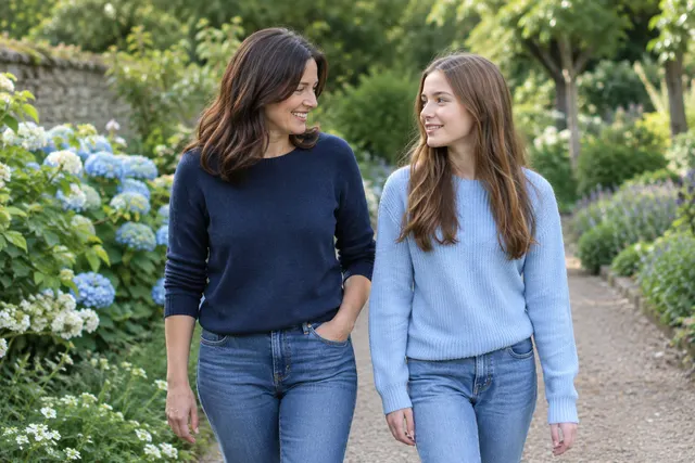 Mother and adult daughter embracing in a sunlit garden